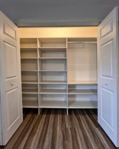 Photo of a reach-in closet with one hanging rack and lots of shelving space.